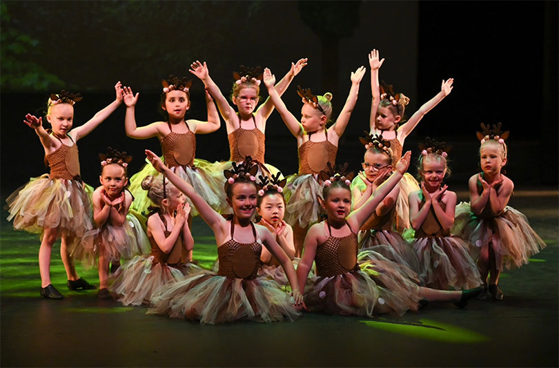 a crew of young jazz dancers perform in the production of Rapunzel. They wear tutu's.